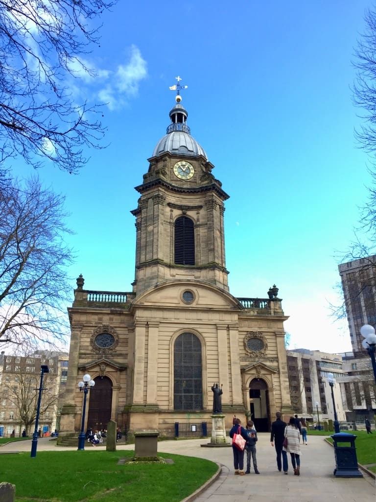 Birmingham Cathedral from the churchyard on Colmore Row, with the clock tower against a clear sky